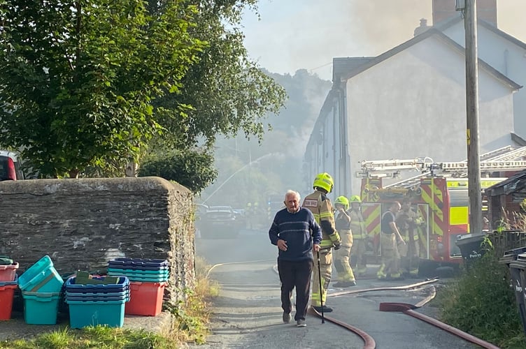 Firefighters use hoses to tackle the blaze at a house on Poplar Terrace.