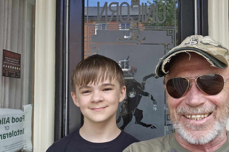 Michael Freed outside the Unicorn with his son, the day he got the keys to the hotel. Photo: Michael Freed