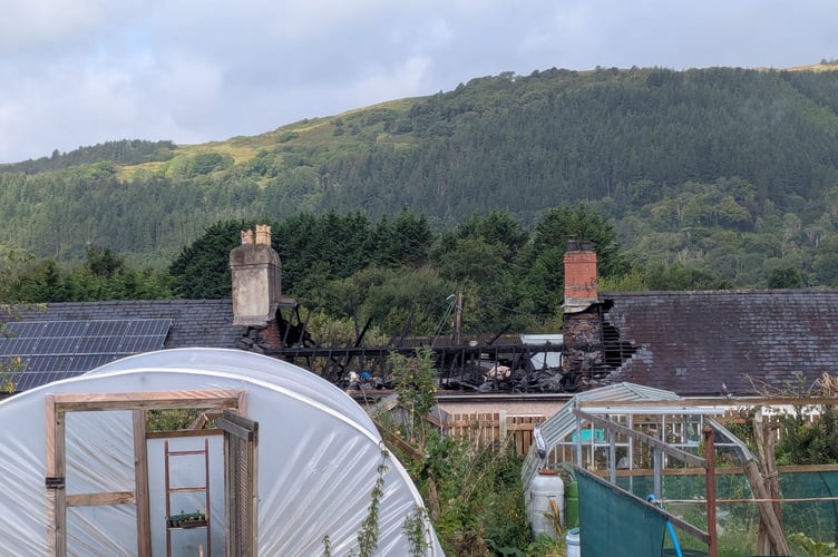 The fire-damaged roofs of two houses. Photo: Cambrian News
