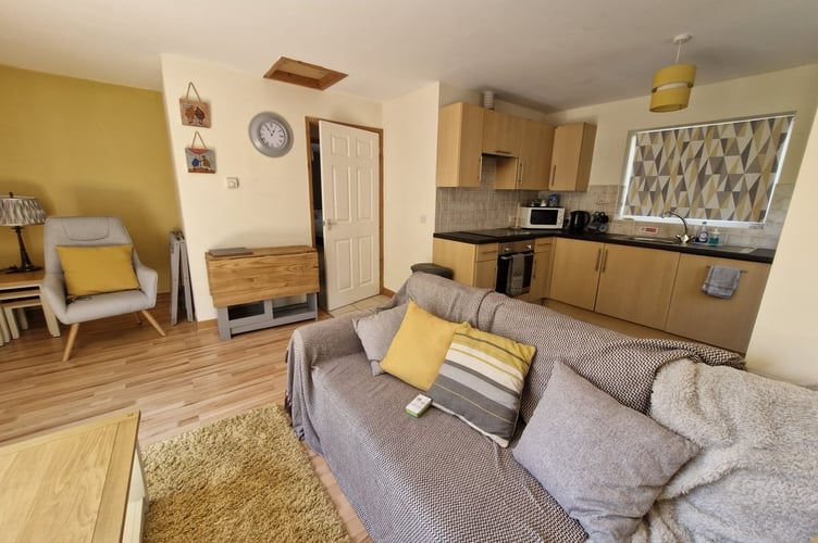 A wide view of the bugalow's living room and kitchen area. Photo: Bond Wolfe