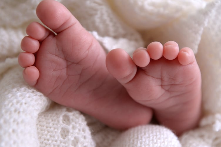 Undated file photo of a new born baby's feet are visible peeking out of a shawl. The fertility rate for England and Wales has fallen for the third year in a row to reach a new record low, figures show. The total fertility rate across both nations, defined as the average number of live children women would expect to have across their childbearing life, stood at 1.41 in 2024. Issue date: Wednesday August 27, 2025.