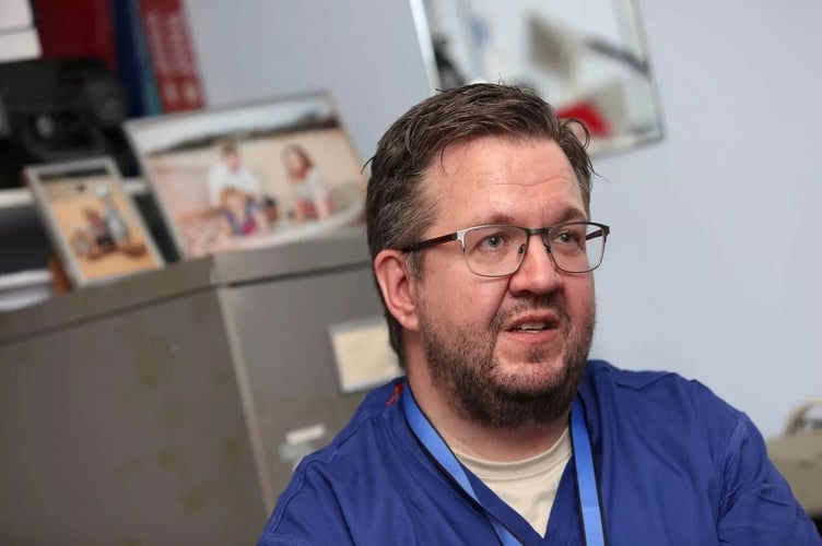 FILE PHOTO - Surgeon Neil Hopper at The Royal Cornwall Hospital. A vascular surgeon who carried out hundreds of amputation operations before going on to have both his own legs amputated has been charged with fraud.  Neil Hopper, aged 49, from Truro, has also been charged with encouraging someone else to remove the body parts of others. Devon and Cornwall Police issued a statement this morning saying: "Following an investigation by Devon and Cornwall Police which began in February 2023, a vascular surgeon from Cornwall has been charged with three criminal offences.