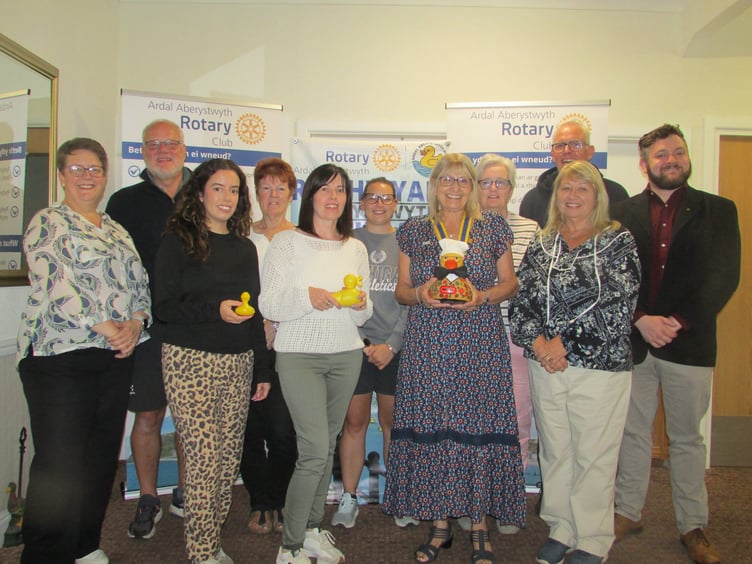 Duck race team with Anya Edwardes (3rd left) 2nd place winner; Lowri Rice (5th left) 1st place winner; Barbara Salerno (President – centre with Duck Race mascot Jeremy Duck)
