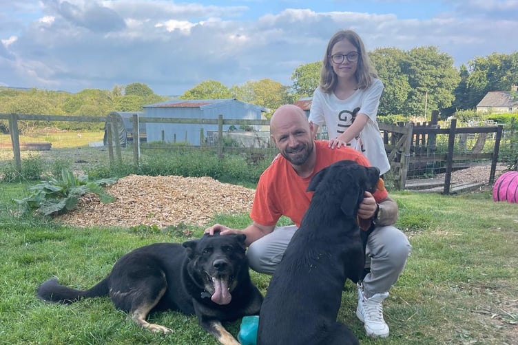 A family with some of the foster dogs at Second Chances Animal Sanctuary. Photo: Second Chances Animal Sanctuary