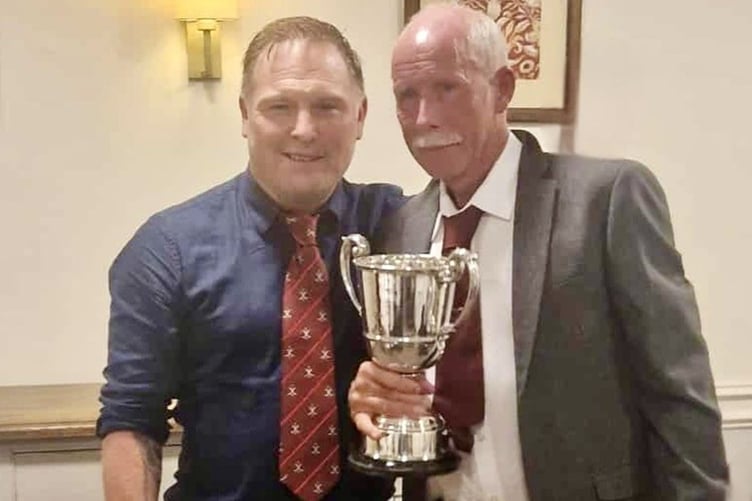 Captain Nick Downing presenting the Convention Cup to Richard Jones