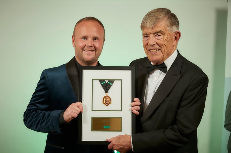 Dyfan Jones, ophthalmic director at Specsavers Porthmadog, receives his award