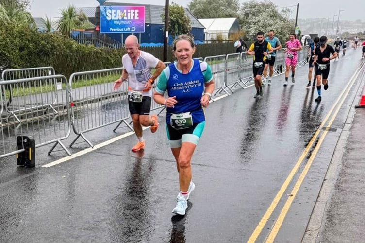 Elaine Rowlands battling the conditions at Weymouth