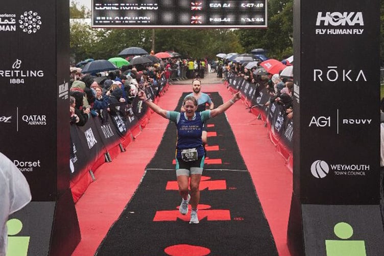 Elaine finishing the IRONMAN 70.3