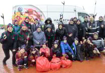 Pwllheli pupils clean beach in wind and rain