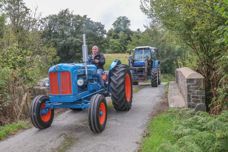 Dylan Davies with another of his imaculate tractors heads over Lan Cych bridge