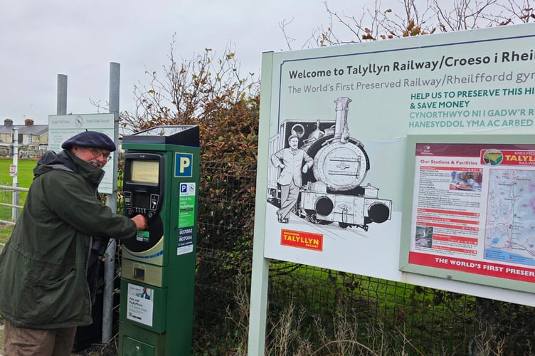 Dr Simon Spencer grapples with the machine at Talyllyn Railway car park