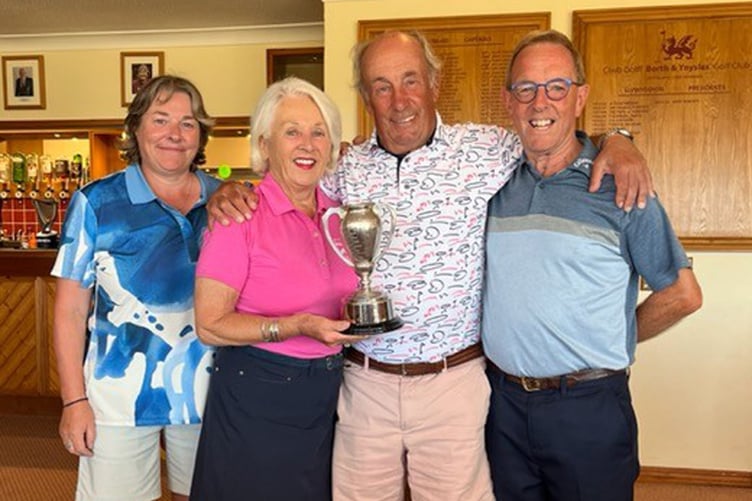 Rob Walker and captain Helen Lewis present the Walker Cup to Helen and Mike Young