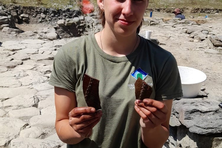 A participant holding a selection of pottery finds in 2025.