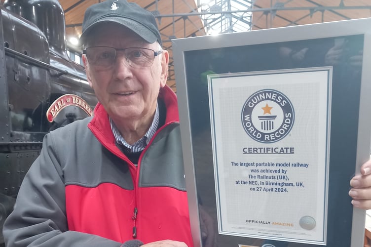 Pete Waterman OBE and the Guinness World Record certificate for making the largest portable model railway in the world. Photo: Julie McNicholls Vale