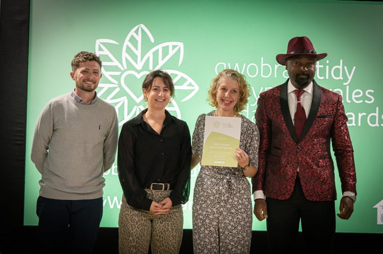 Dafydd Wyn from S4C, left, hosted the awards, and a representative from Huws Grey, right, presented teacher Ffion Hughes and Joanna Jordan from the PTA with the Keep Wales Tidy Award