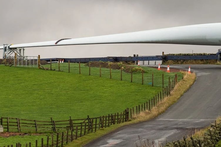 A wind turbine blade being transported to a site in Scotland. But how would 100-metre blades be able to move across our old roads, narrow lands, and steep hills and valleys in mid and west Wales?