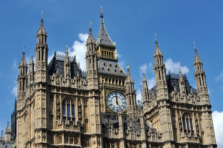 A view of a section of the Houses of Parliament, and the Elizabeth Tower, central London from the River Thames.