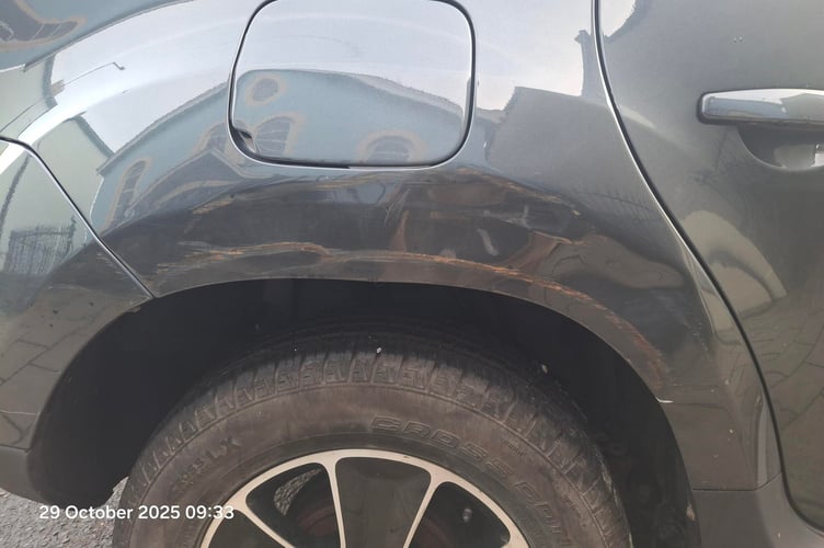 A car which sustained body damage from hitting the new telegraph pole. Scratch marks from the wooden pole are visible on the bodywork. Photo: Leigh Denyer