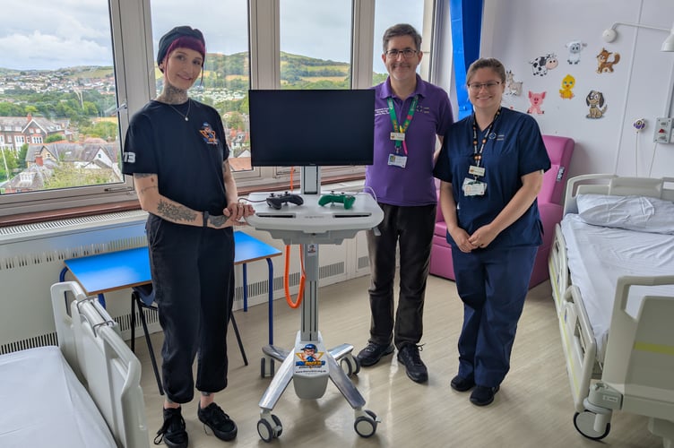 Jess Miree, co-founder of the RockinR Gaming Charity with staff members from Angharad Ward