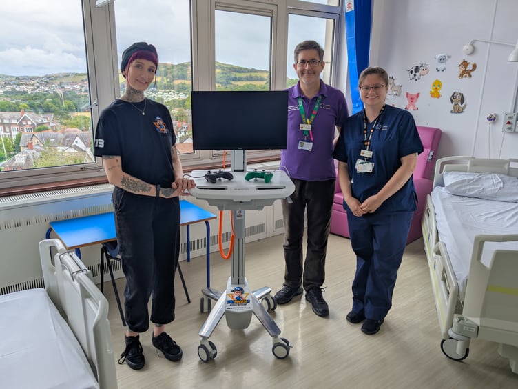 Jess Miree, co-founder of the RockinR Gaming Charity with staff members from Angharad Ward