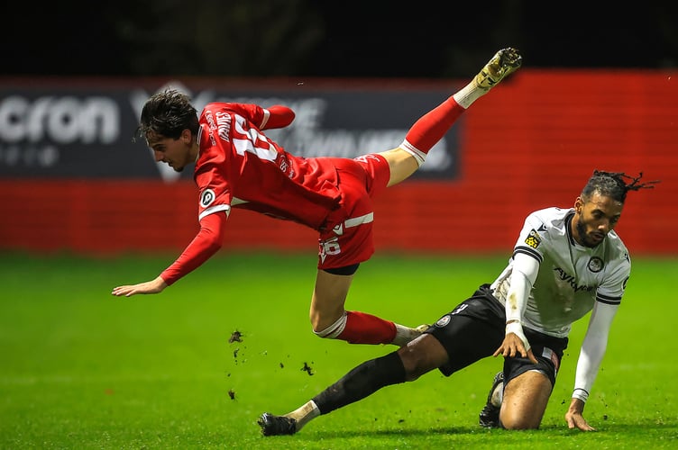 Neath, Wales - 07 November  2025: Ruben Davies of Briton Ferry Llansawel AFC battles for the ball with Nelson Digbeu of Bala Town   during the 2025/26 JD Cymru Premier league fixture between Briton Ferry Llansawel & Bala Town  at The Renewable Centre Stadium, Neath, Wales.  (Pic by Geraint Nicholas/FAW)