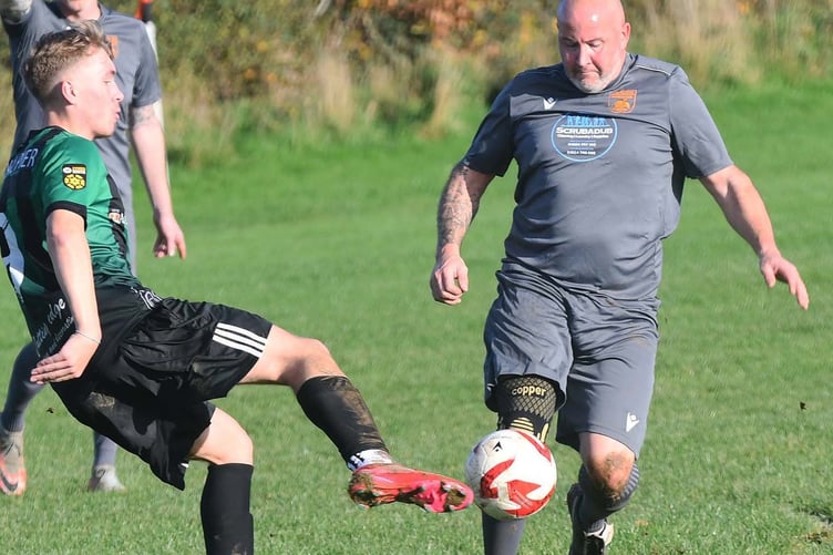 Tywyn's Adam Ebery battles for possession (Photo: Doris O'Keefe)