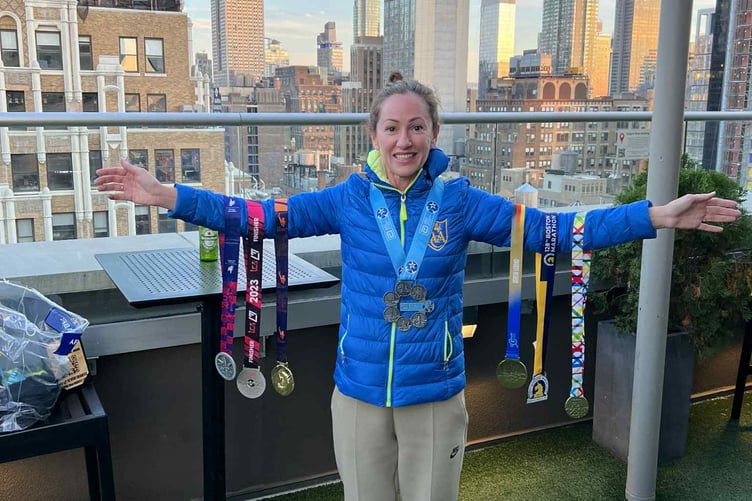 Tracey Breedon with her six marathon medals and the Six Star medal