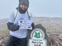 Soldier battles horizontal wind and rain on Pen y Fan in memory of nan