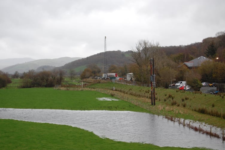 The new trains were spotted alongside flooded fields outside Machynlleth station. Photo: Cambrian News