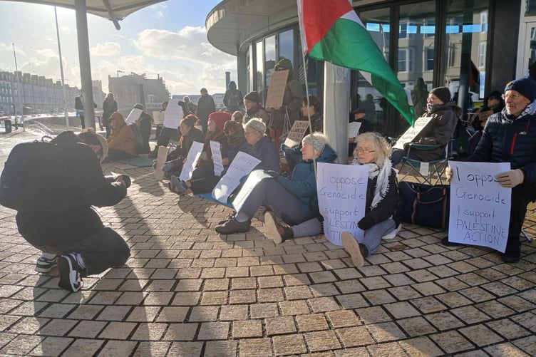 Protestors and their signs before arrests began.