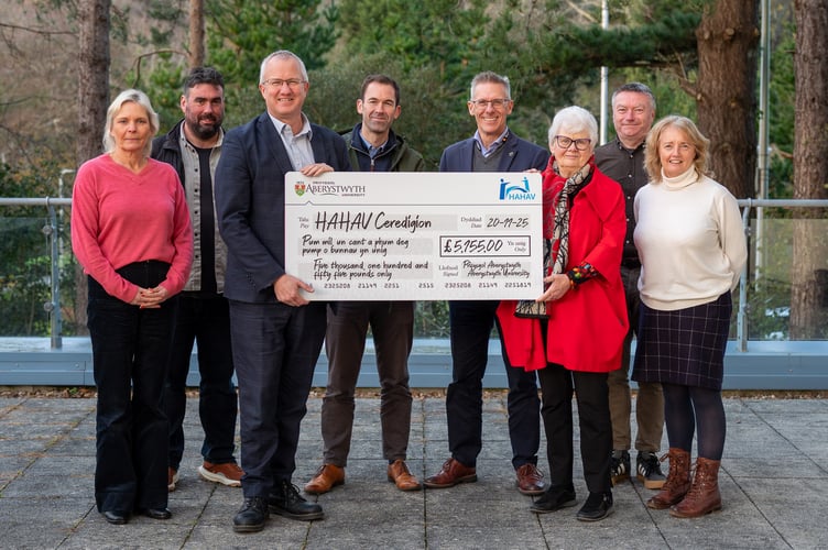 Vice Chancellor, Professor Jon Timmis and university staff present a cheque to Gwerfyl Pierce Jones, chair of HAHAV Ceredigion. Photo: Aberystwyth University