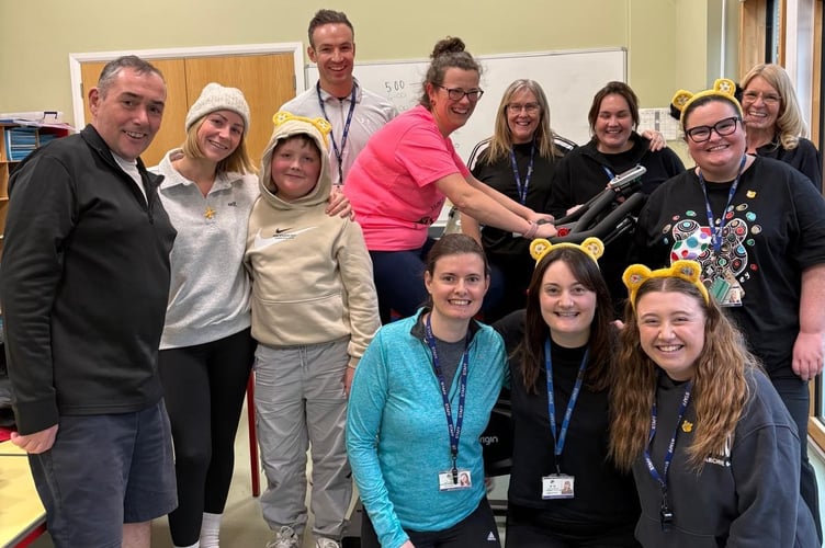 Rufus (middle left) with his mum Rosie and staff at Comins Coch Primary School, who cycled 250 miles on Friday 14 November to raise funds to support the family. Photo: Rosie Palmer