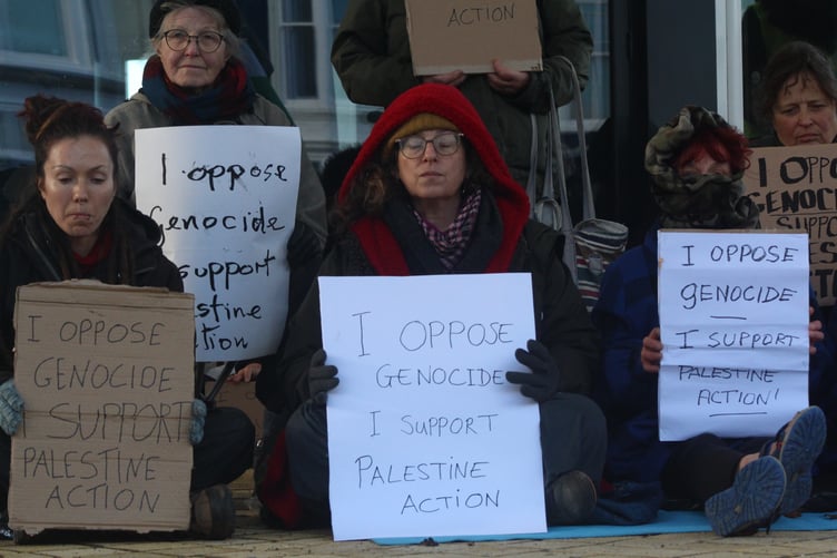 The protestors sat in silence for an hour before the police arrived in four vans.