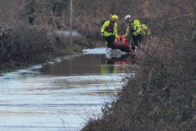 Van driver rescued from floodwater
