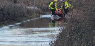 Van driver rescued from floodwater