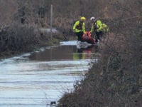 Van driver rescued from floodwater