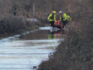 Van driver rescued from floodwater