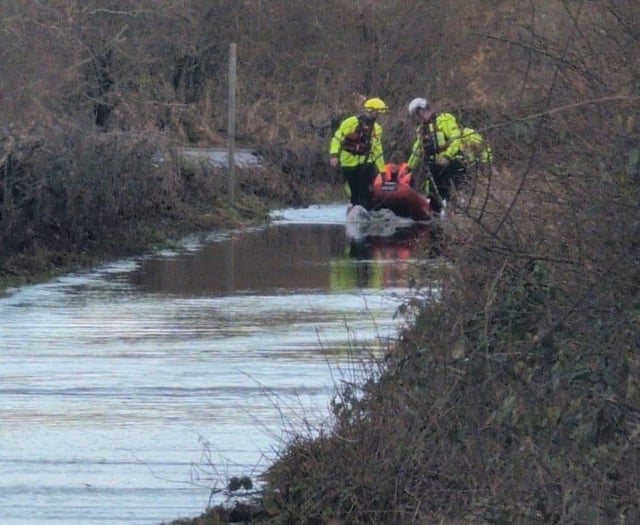 Van driver rescued from floodwater