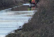 Van driver rescued from floodwater