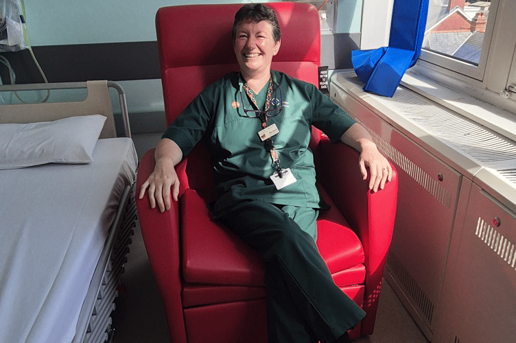 Sian Davies, Health Care Support Worker sat on a Buddy Day Bed Chair