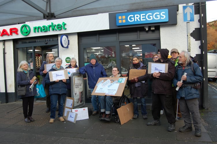 Machynlleth protestors outside the Spar and Post Office, which is due to be downgraded next month. Photo: The Cambrian News