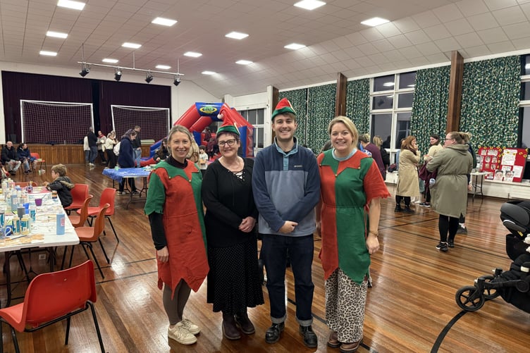 Cllr Glyn Preston with elves at the free Christmas family event in Llanidloes on 15 December. Photo: Powys Together