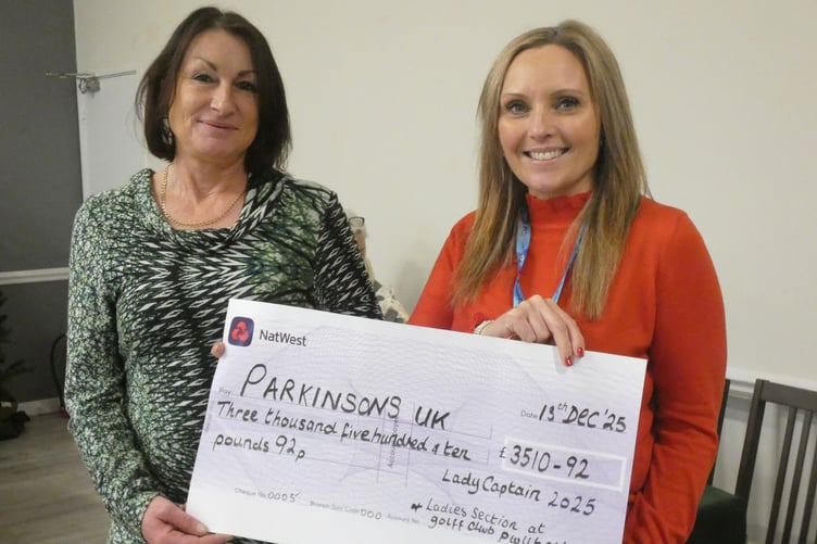 Lady Captain Anna Bischoff presents the cheque to Keri McKie of Parkinsons UK Cymru