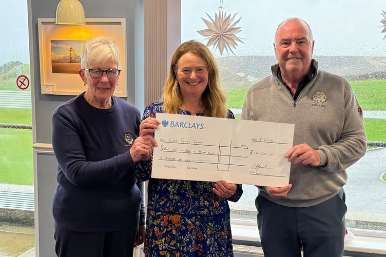Cemlyn Howel and Pam Kempley present the cheque to Jacquie Hughes-Jones