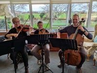 Totaleigh Music Trio brings Christmas cheer to Tywyn care homes