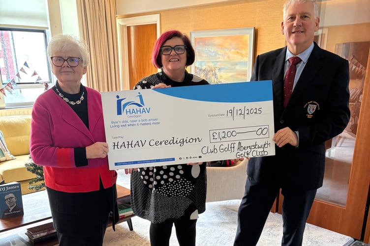 Dave Houghton making the contribution to HAHAV Ceredigion chair Gwerfyl Pierce Jones and chief officer Rhian Dafydd