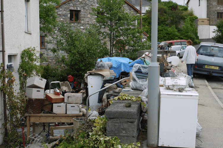 Mick and Jenny start to dry out their belongings after the flood.