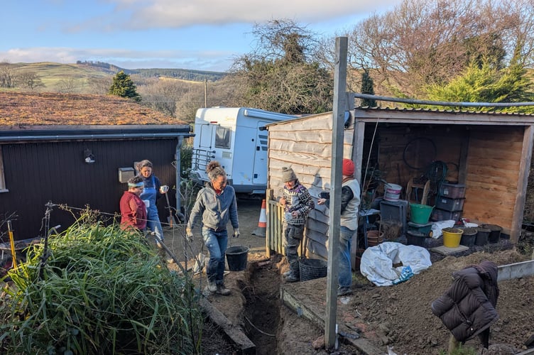 A football team came to the aid of a loo-less mum by digging up and replacing a collapsed pipe