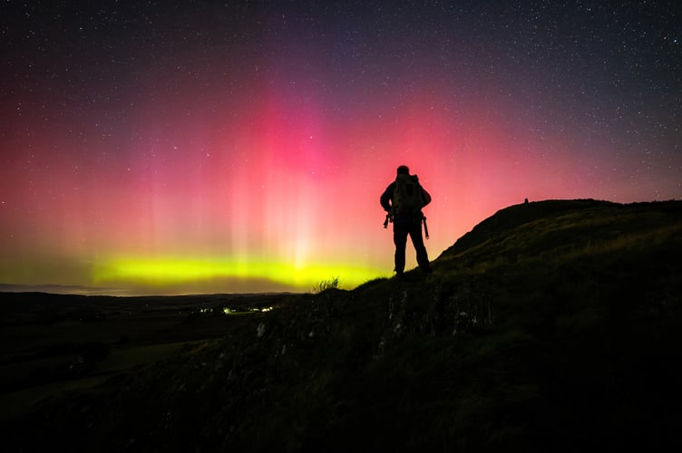 Dafydd Wyn Morgan with the aurora borealis in the Cambrian Mountains.