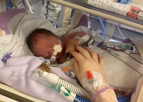  Sonny Taylor. A newborn baby left distressed for a significant amount of time died after medics didnt wake his mum for potentially life-saving observations, an investigation found. Sonny Taylor was delivered in a poor condition via emergency caesarean at Ysbyty Gwynedd Hospital in Bangor, Wales, after he was found to have had a low heart rate.Hours earlier midwifery staff wrongly left his mum Eve   who had been admitted to hospital after her waters broke at 36 weeks pregnant - sleeping instead of waking her for observations and to listen to Sonnys heart rate, an internal NHS investigation report seen by the familys legal team at Irwin Mitchell said.
